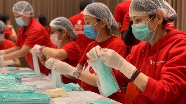Image of volunteers packing care kits for Save The Children